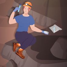 Image of female scientist crouching as she collects samples in a cave.