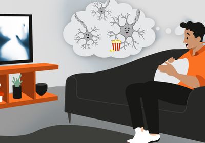 Cartoon showing the neurons in the brain enjoying the frightening movie the person is watching.