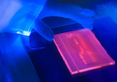 Close up of ultraviolet light box during the preparation of an agarose electrophoresis gel used in DNA separation.