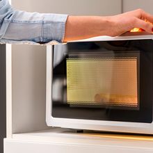 Image of a person closing a microwave oven door