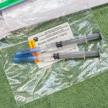 Two vaccine syringes on a baggy labelled with San Diego Zoo and Bonobo