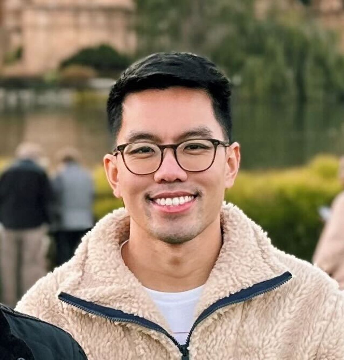 Ivan Alcantara is a neuroscience graduate student at the National Institute of Diabetes and Digestive and Kidney Diseases. He is smiling in the photo and wearing a beige jacket and rounded glasses. 