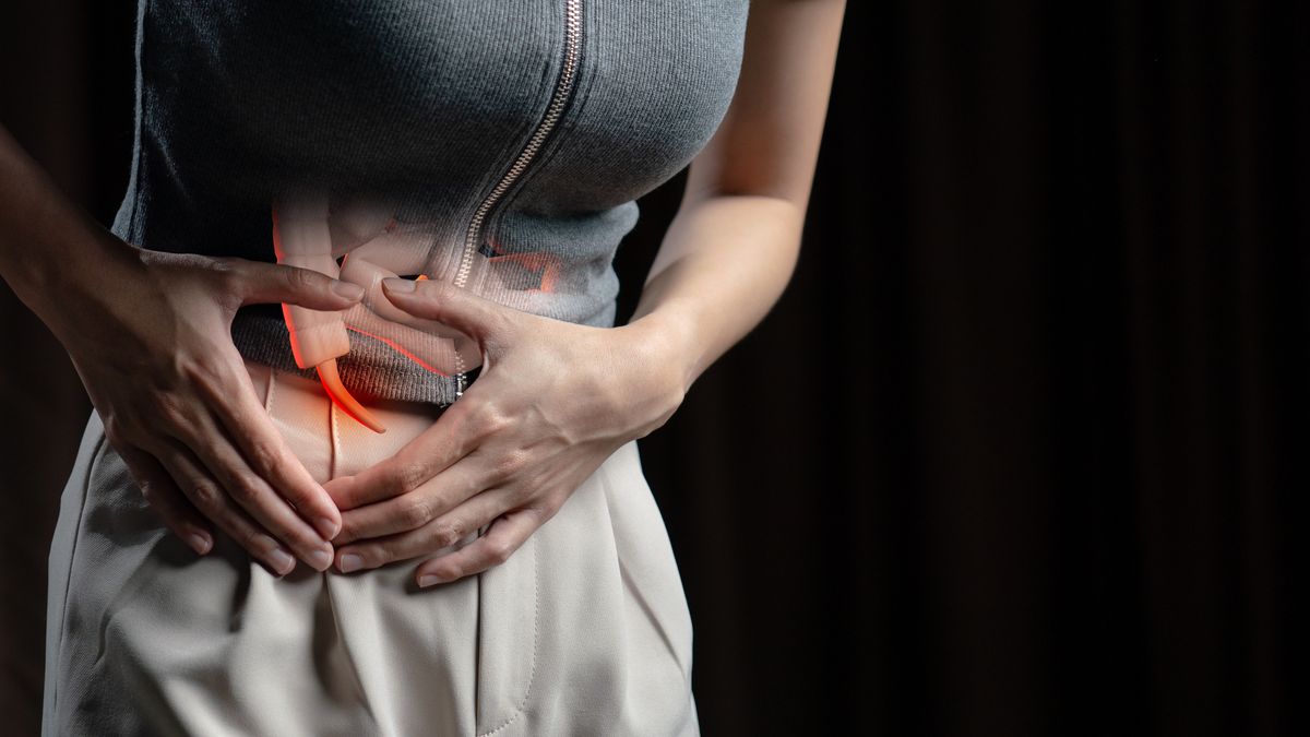 A woman experiencing stomach pain, potentially related to appendicitis.