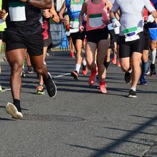 Image showing the legs of multiple people running in the street.&nbsp;