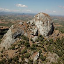 rock formation rising out of a plain